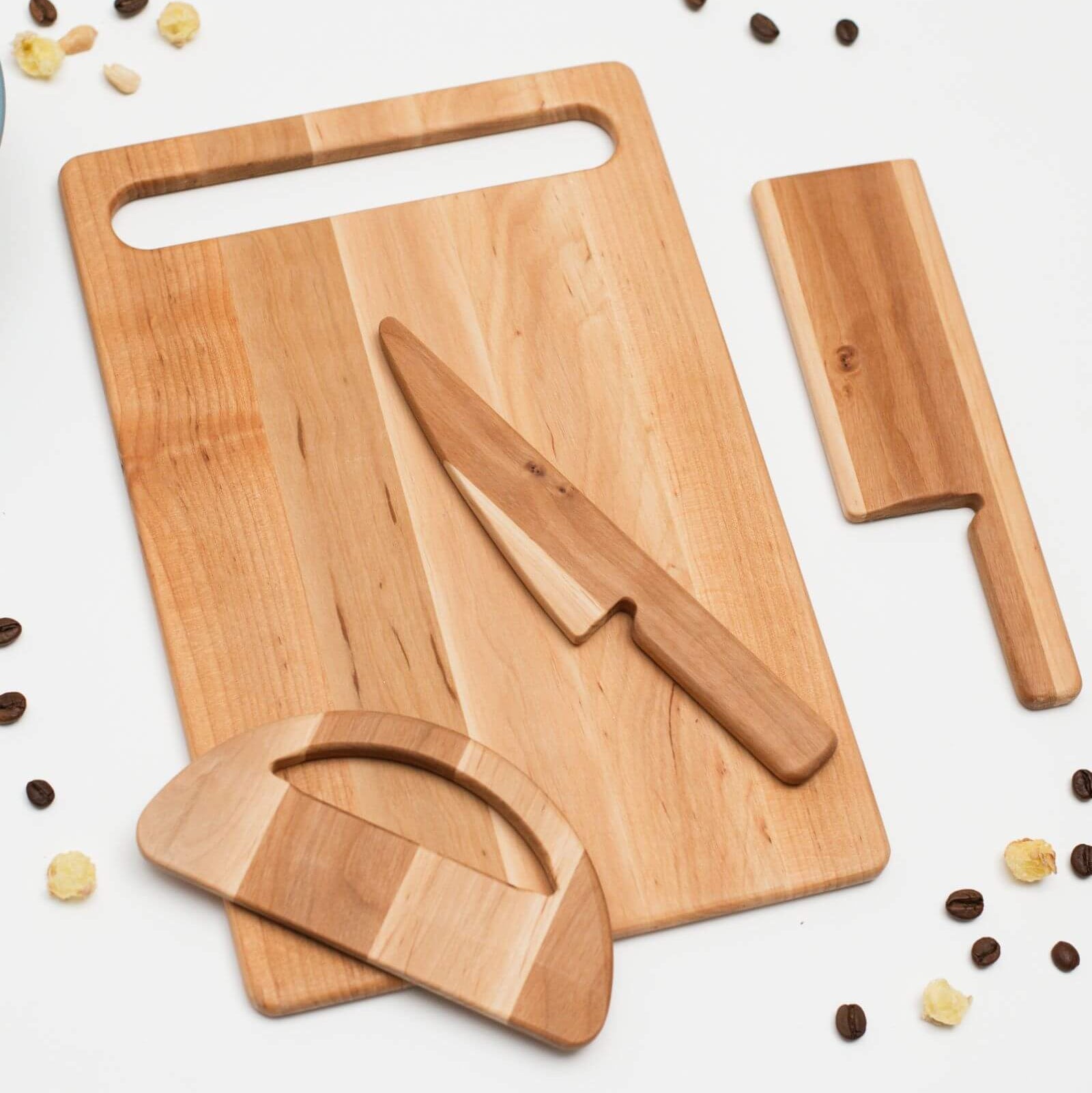 Wooden cutting board with knife and accessories on a white background