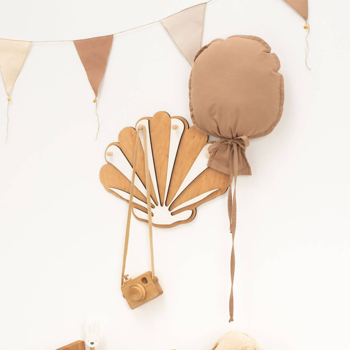 Brown shell-shaped bag with a camera attached on a white background