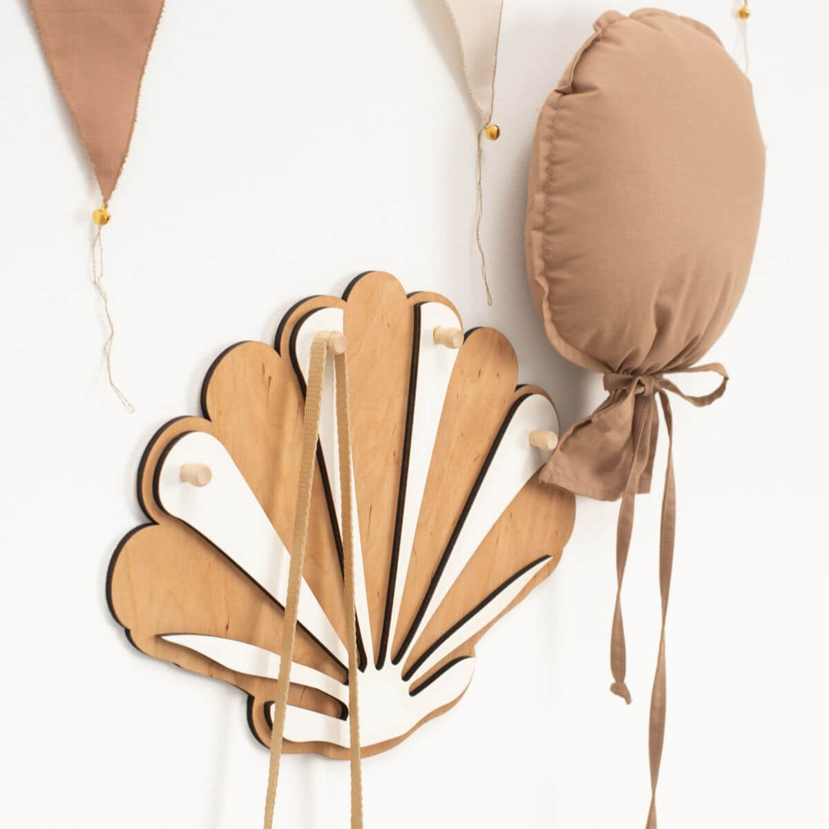 Decorative leaf-shaped item with a bow on a white background