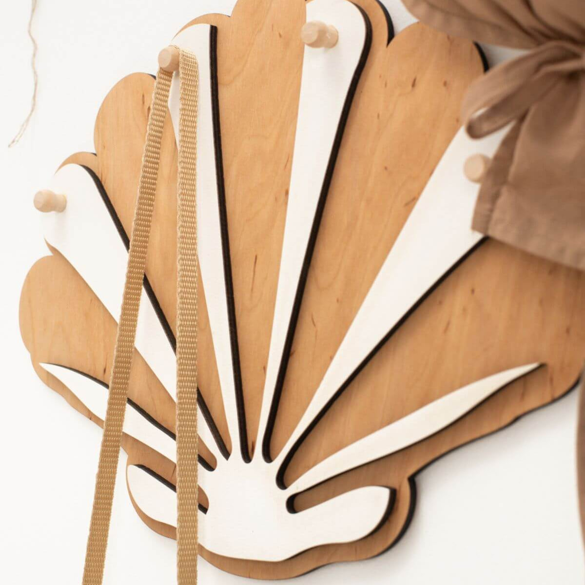 Wooden wall art with fan-like design on a white background