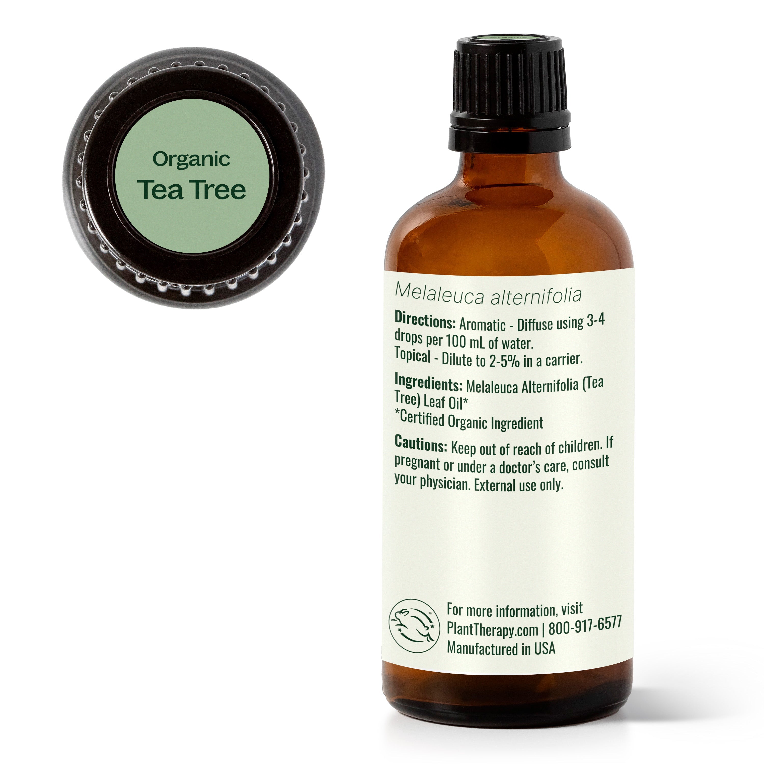 Bottle of organic tea tree oil with label on a white background