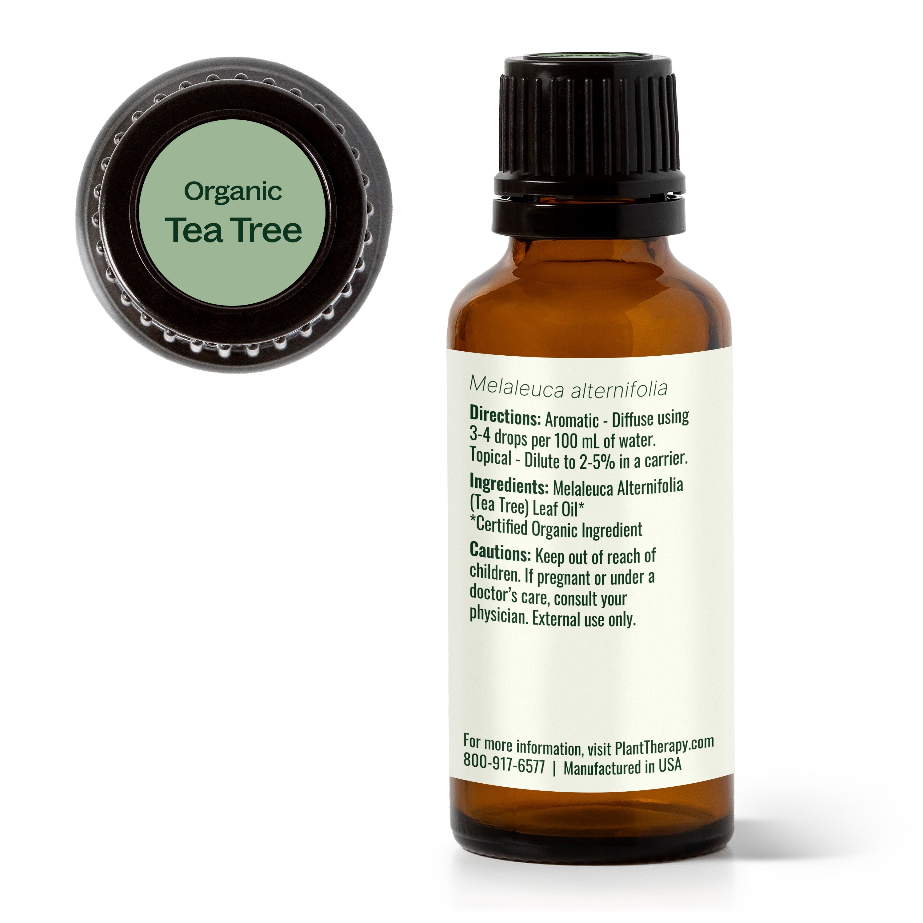 Bottle of organic tea tree oil with label on a white background