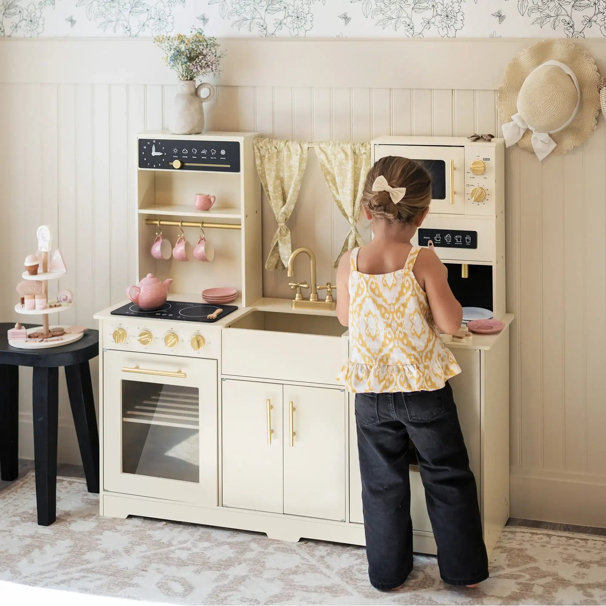 Child pretending to cook with play kitchen set