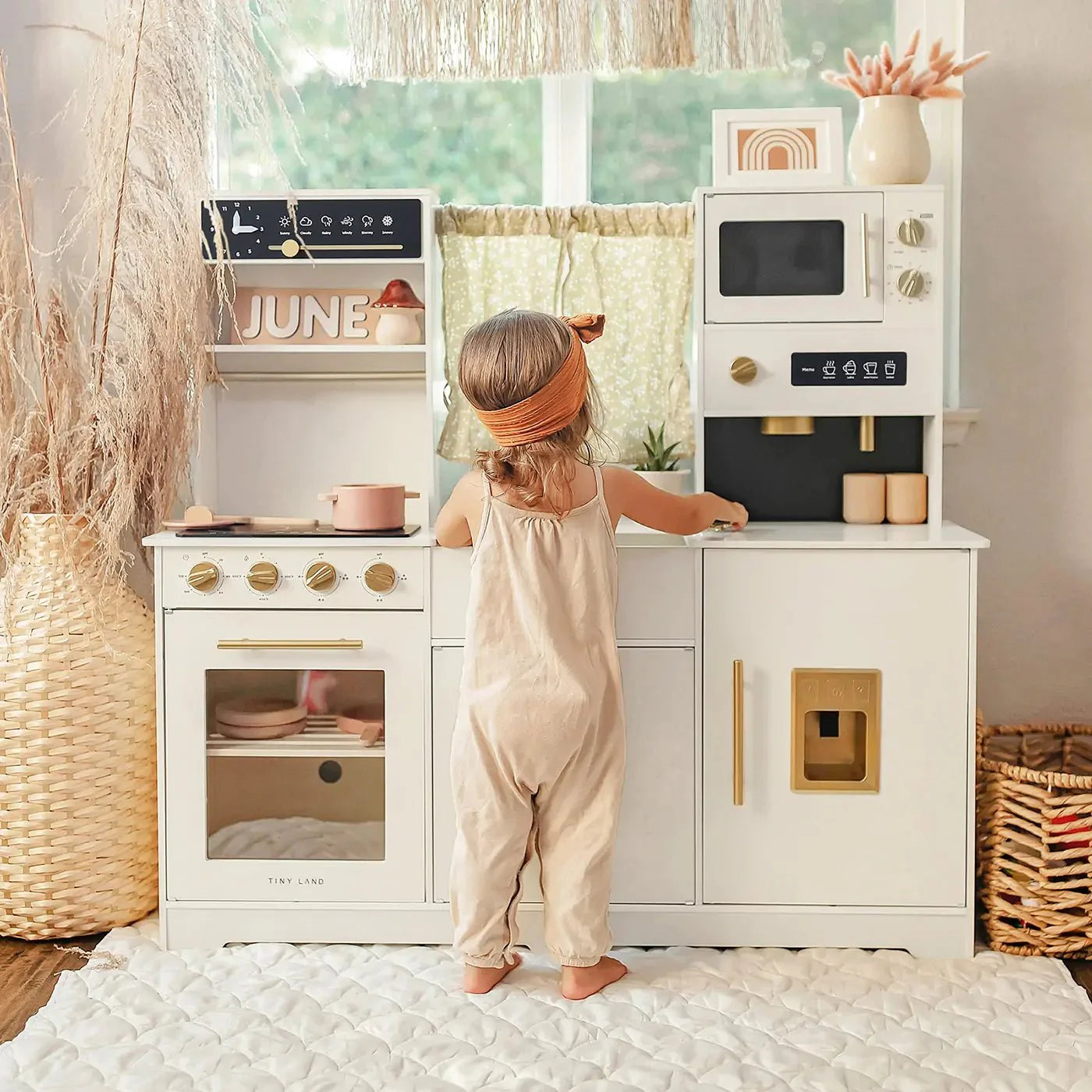 Child at sink of play kitchen