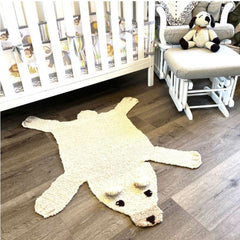 Organic wool polar bear play mat in a calm neutral nursery setting