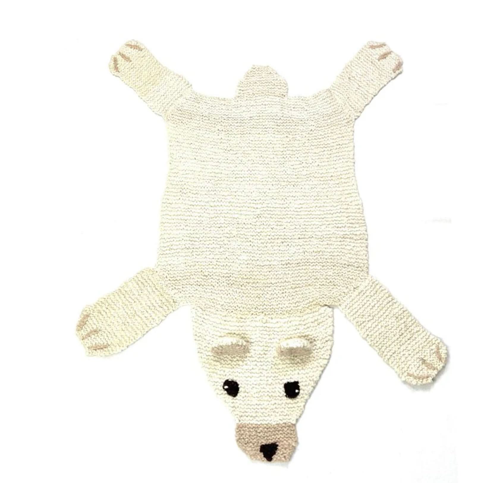 Organic wool polar bear nursery rug on white background showing hand-knit texture and design