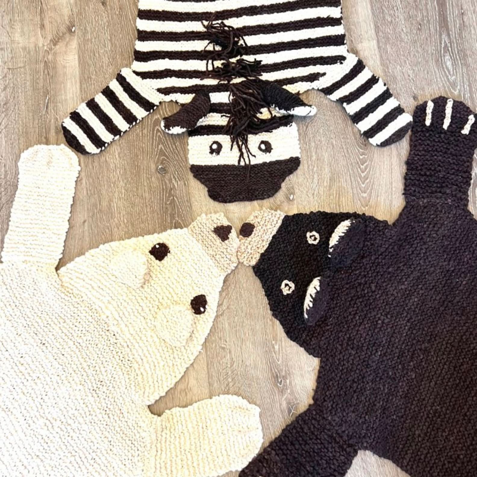 Three organic wool animal play mat designs displayed together — brown bear, zebra, and polar bear