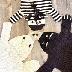 Three organic wool animal play mat designs displayed together — polar bear, zebra, and brown bear