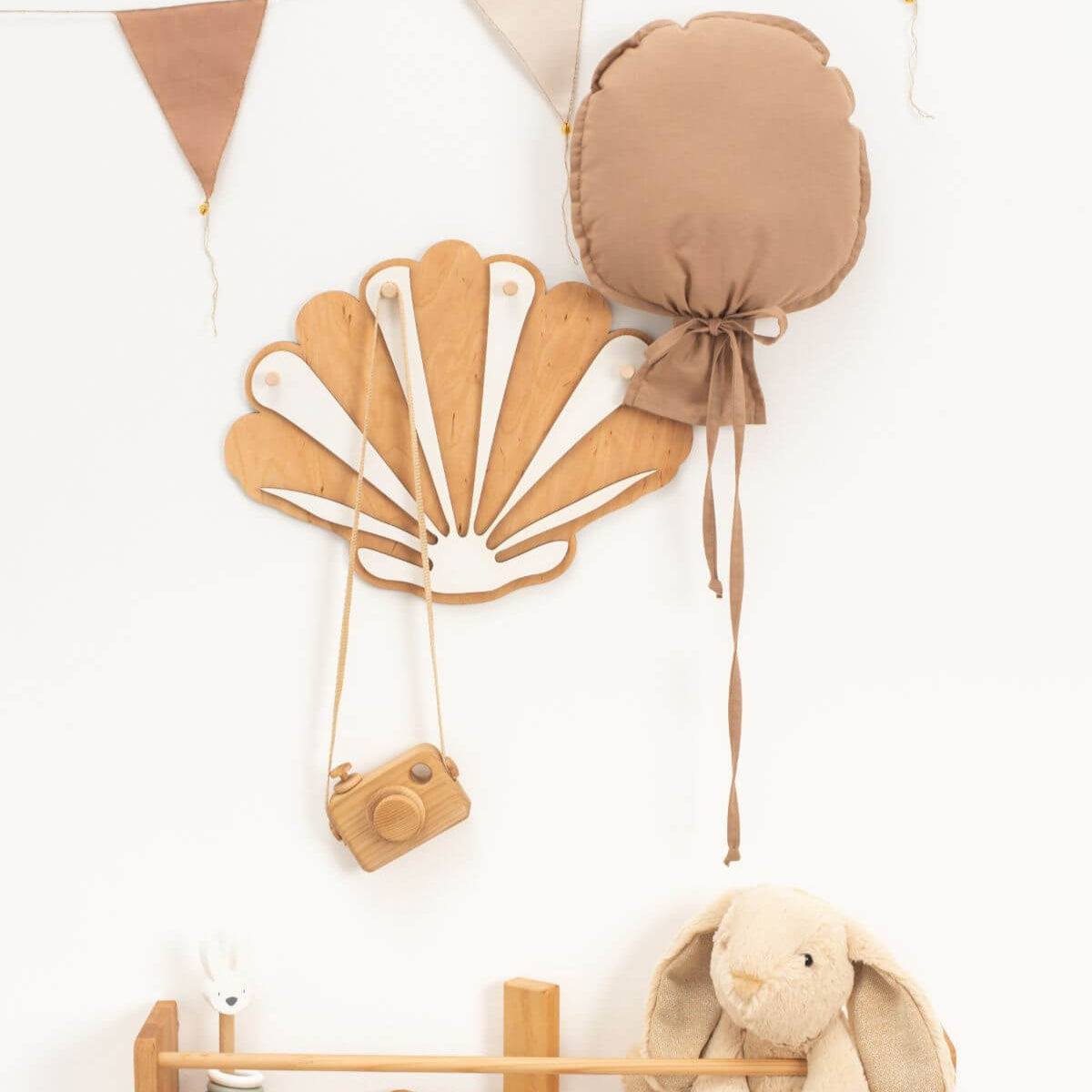 Set of decorative items including a shell, camera, and plush rabbit on a white background