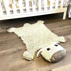organic wool sheep play mat in a calm neutral nursery setting