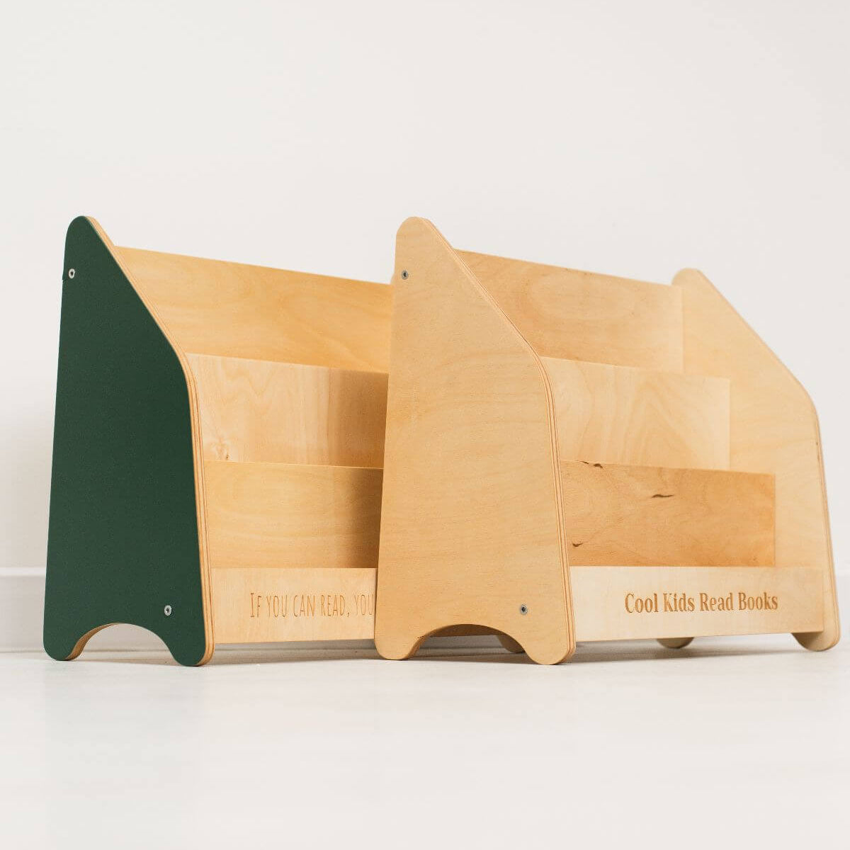 Wooden bookshelf with green and beige sections on a white background