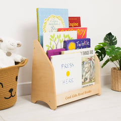 Wooden bookshelf with children's books and a toy on a white surface.