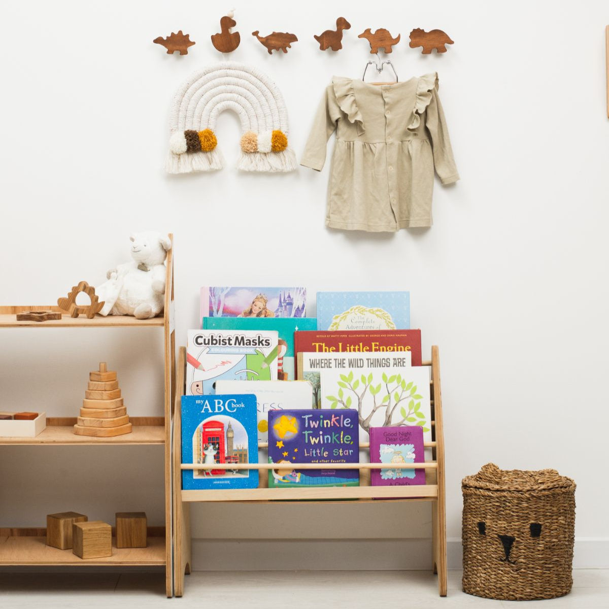 Children's room with wooden bookshelf, toys, and wall decorations.