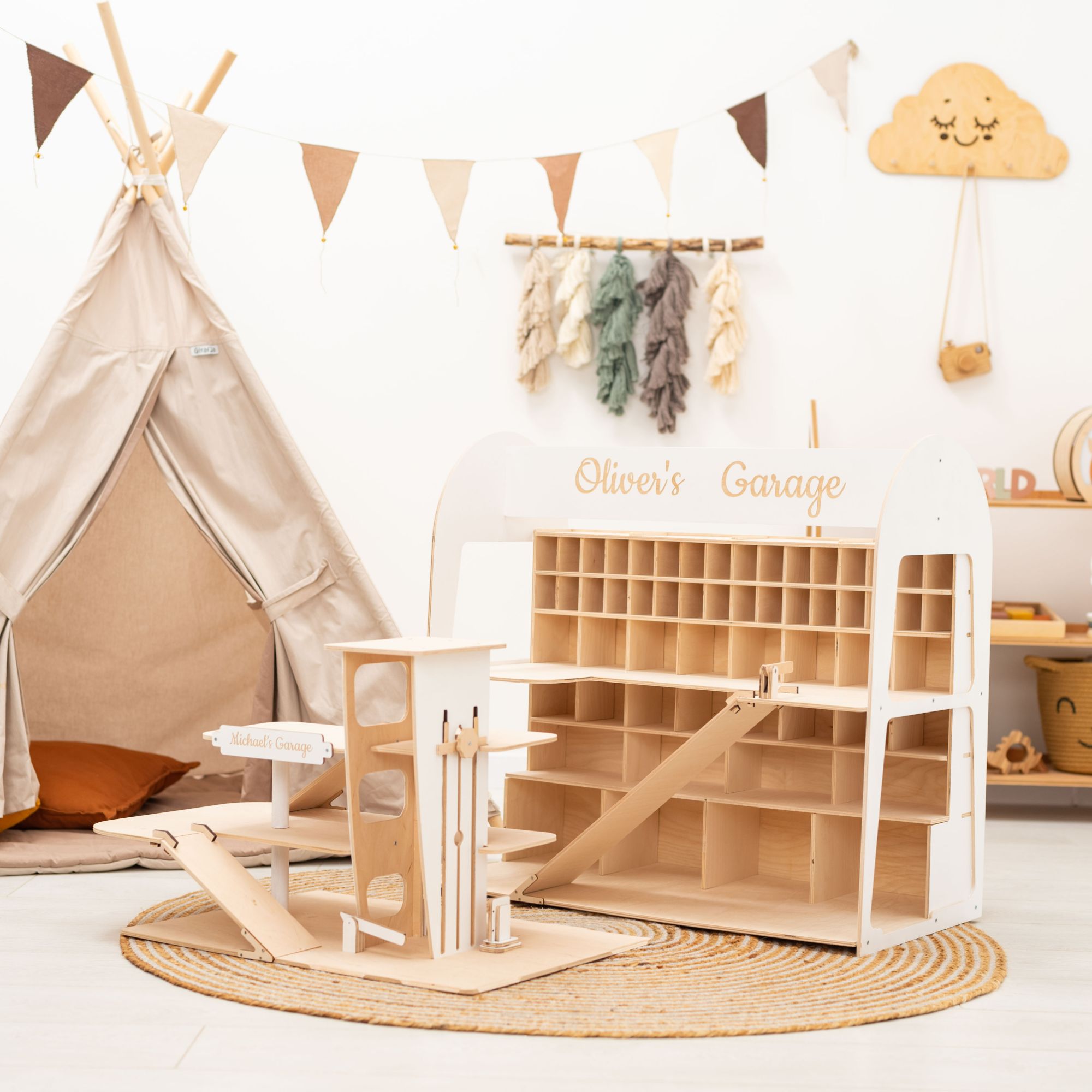 Children's playroom with a teepee, toy garage, and hanging decorations.
