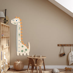 Dinosaur-shaped growth chart on a wall in a child's room with wooden furniture and decor.